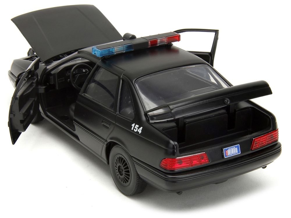 Ford Taurus OCP Matt Black "Detroit Police" and Robocop Diecast Figure 35th Anniversary "Robocop" (1987) Movie "Hollywood Rides" Series 1/24 Diecast Model Car by Jada view 3