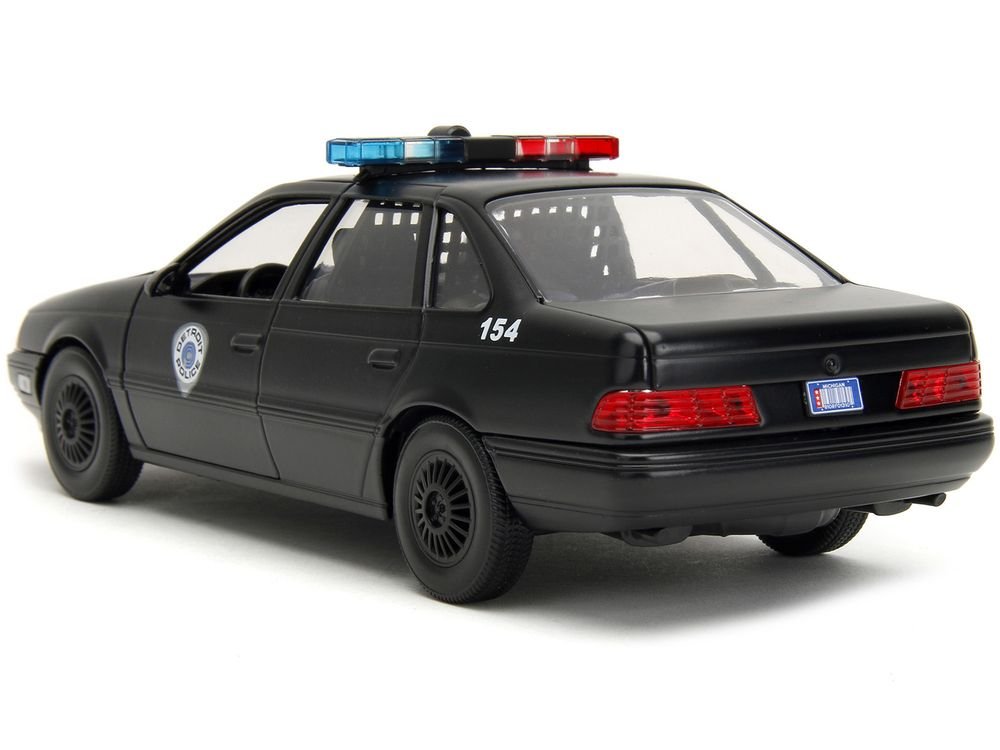 Ford Taurus OCP Matt Black "Detroit Police" and Robocop Diecast Figure 35th Anniversary "Robocop" (1987) Movie "Hollywood Rides" Series 1/24 Diecast Model Car by Jada view 4