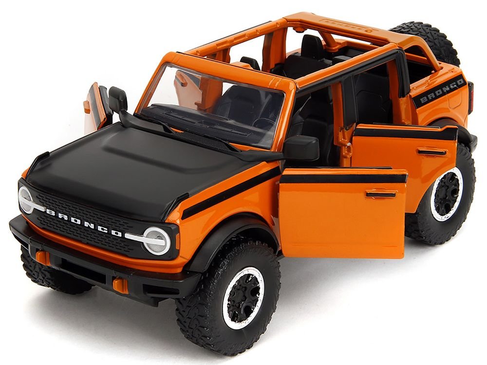 2021 Ford Bronco Open-Top Orange with Black Stripes and Hood with Extra Wheels "Just Trucks" Series 1/24 Diecast Model Car by Jada view 2