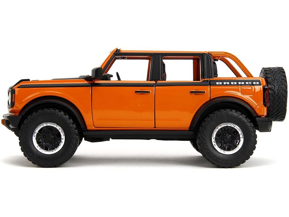 2021 Ford Bronco Open-Top Orange with Black Stripes and Hood with Extra Wheels "Just Trucks" Series 1/24 Diecast Model Car by Jada view 3